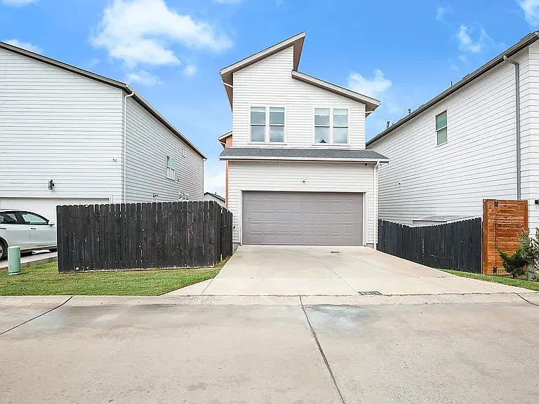 Rear-entry two-car garage accessed via a private alley_offering convenience, extra privacy, and enhanced curb appeal.