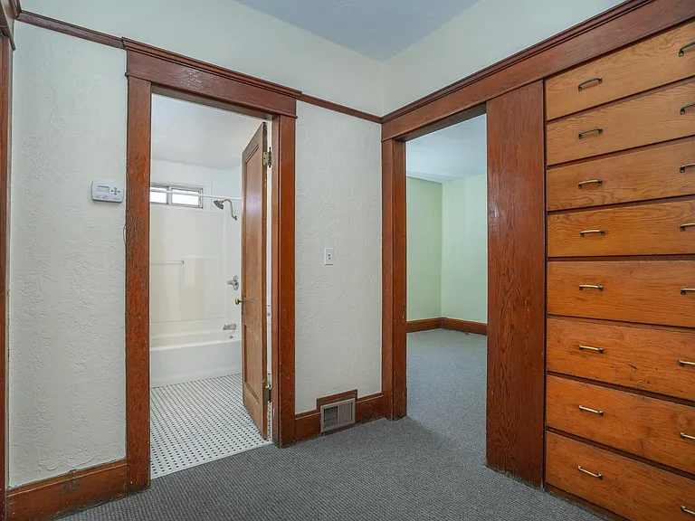 Hallway with Built-In ( Drawers) connecting Kitchen to 2 Bedrooms and Bath. Bathroom with Tub/Shower and Newer Fixtures.