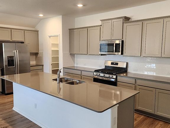 Lots of cabinet and counter space and huge island. Great for entertaining.