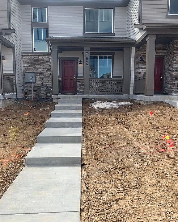 Private front entry with covered porch and brick facia