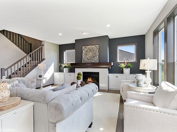 Main level great room with an abundance of light. Photos of similar model