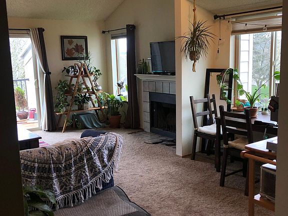 Living room with fireplace and access to second story patio.