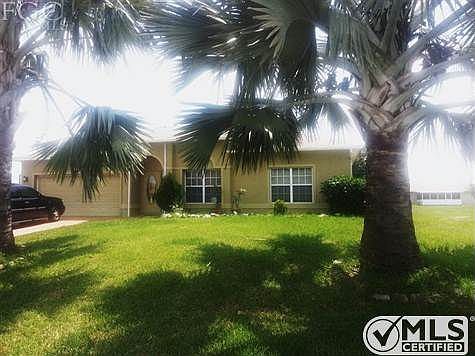 Glass Front Door and Beautiful Front Architecture is graced by 2 large Palm Trees.
