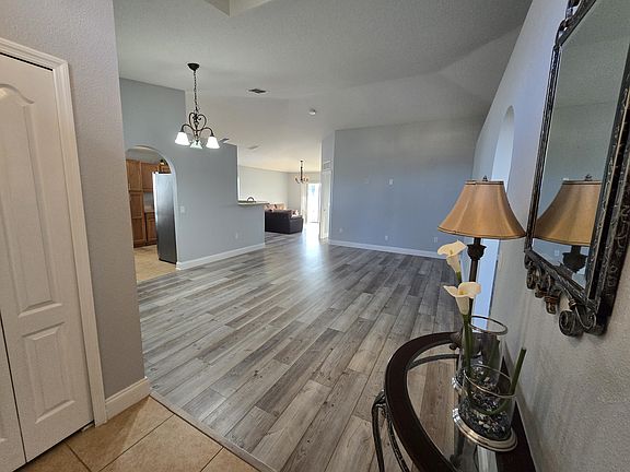 Foyer/Entrance with coat closet to the left and view of large living area.