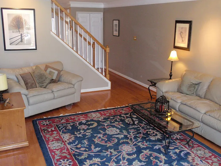 Photo of spacious living room with hardwood floors.