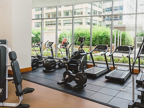 Floor to ceiling windows offer an open and airy atmosphere in our membership-style fitness center