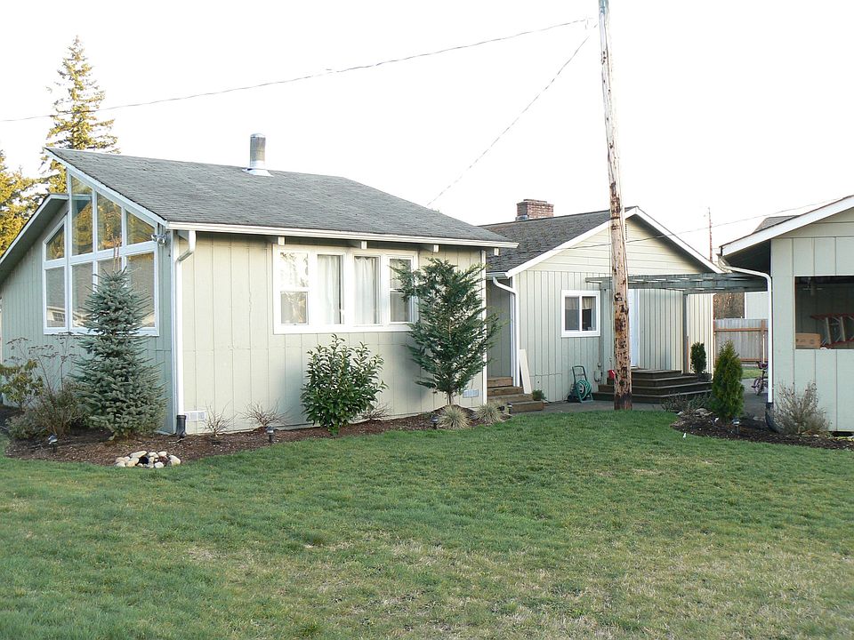 side of Home with part of carport