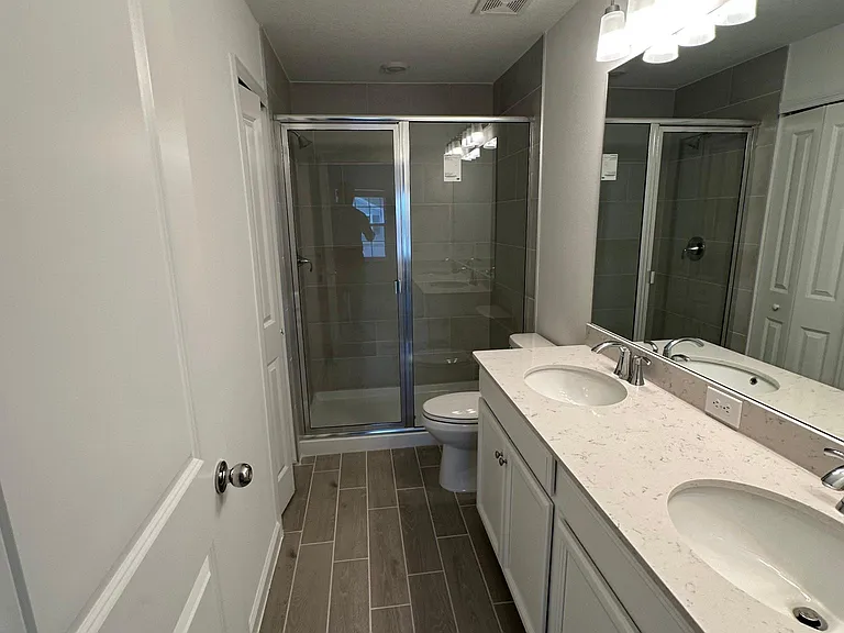 Ensuite bathroom for main bedroom featuring dual sinks and a spacious vanity for your convenience