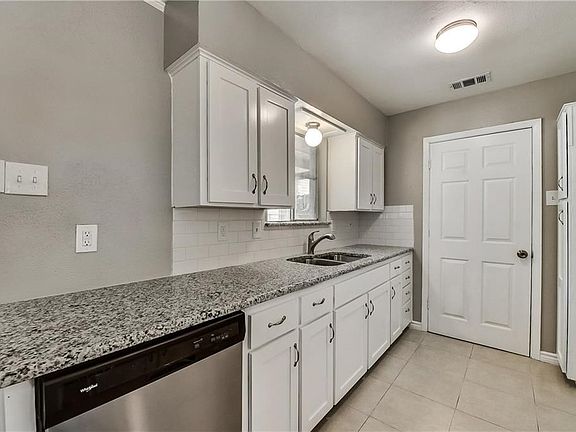 Kitchen with granite and subway tile.