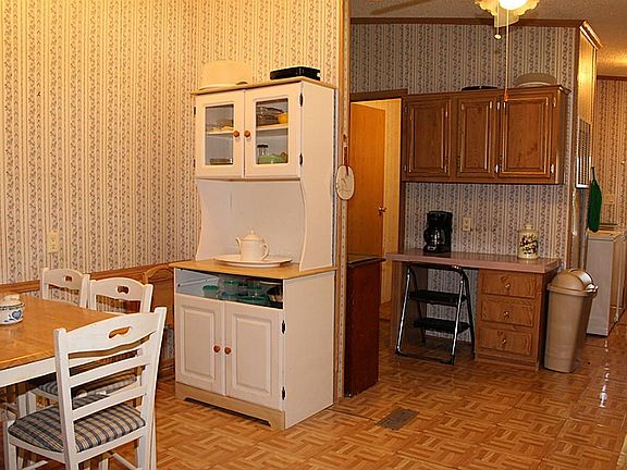 Kitchen Features Vinyl Flooring and Ceiling Fan.