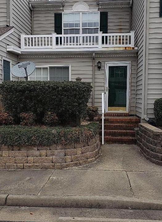 Exterior front. Fenced patio hidden behind shrubs