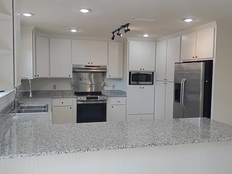 Spacious stainless steel with granite counters kitchen