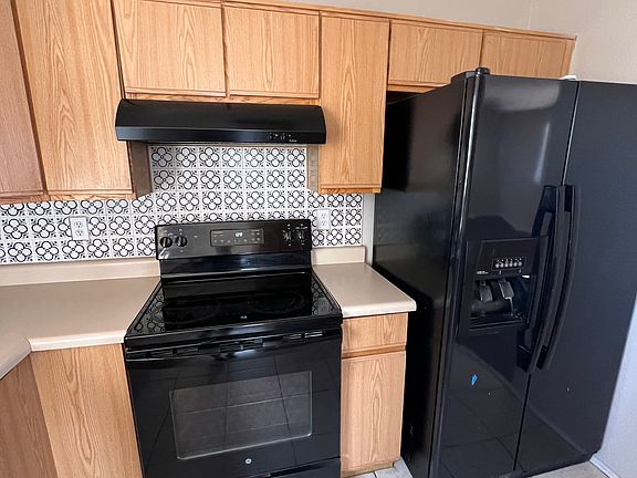 Electric stove and side by side refrigerator. Double stainless sink.