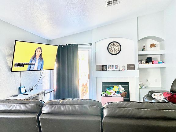 Living room with vaulted ceilings and two tone gray / white paint