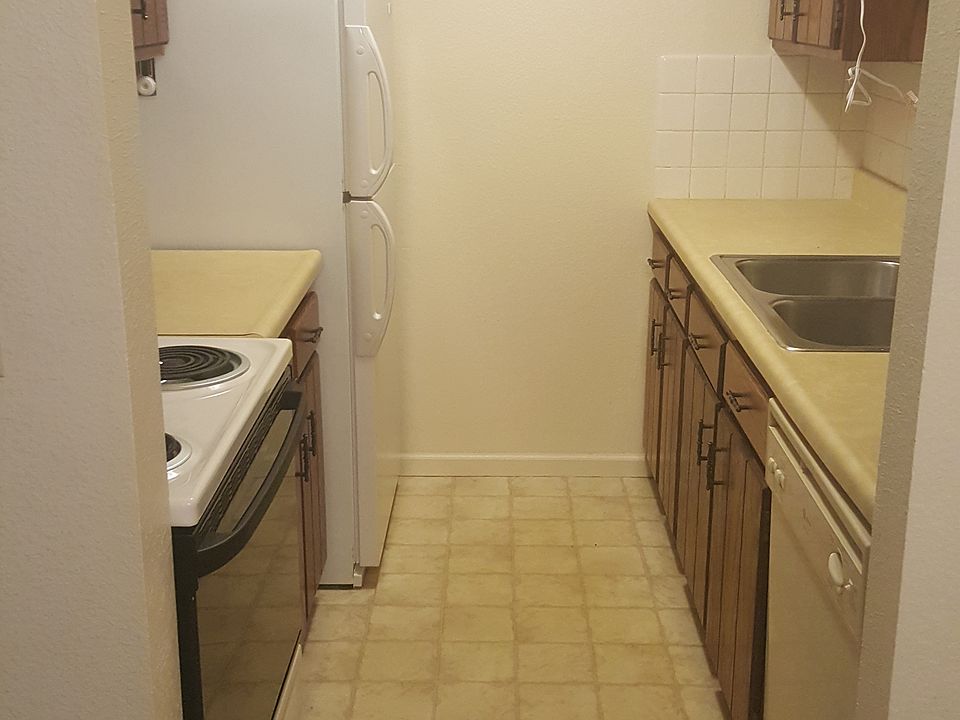 Galley kitchen, full size appliances, dishwasher and ceramic cooktop stove.