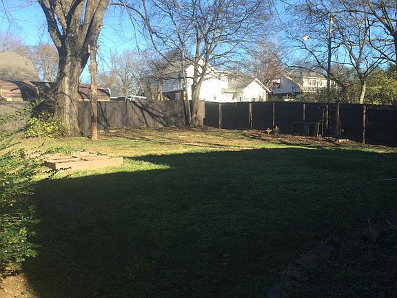 Large fenced back yard with beautiful old trees.