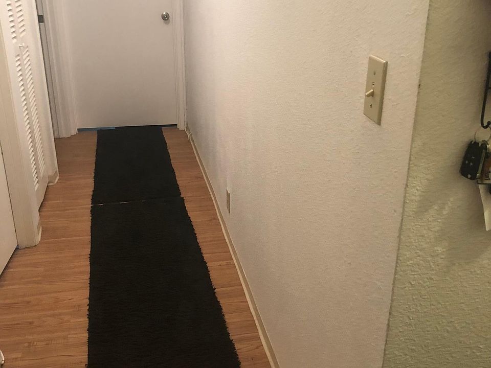 Hallway to two bedrooms and full bathroom