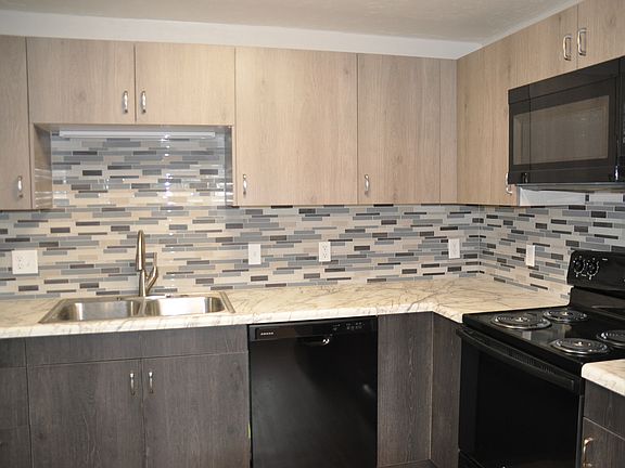 New kitchen cabinets, counter top, tile backsplash, and appliances. Separate pantry in the kitchen.