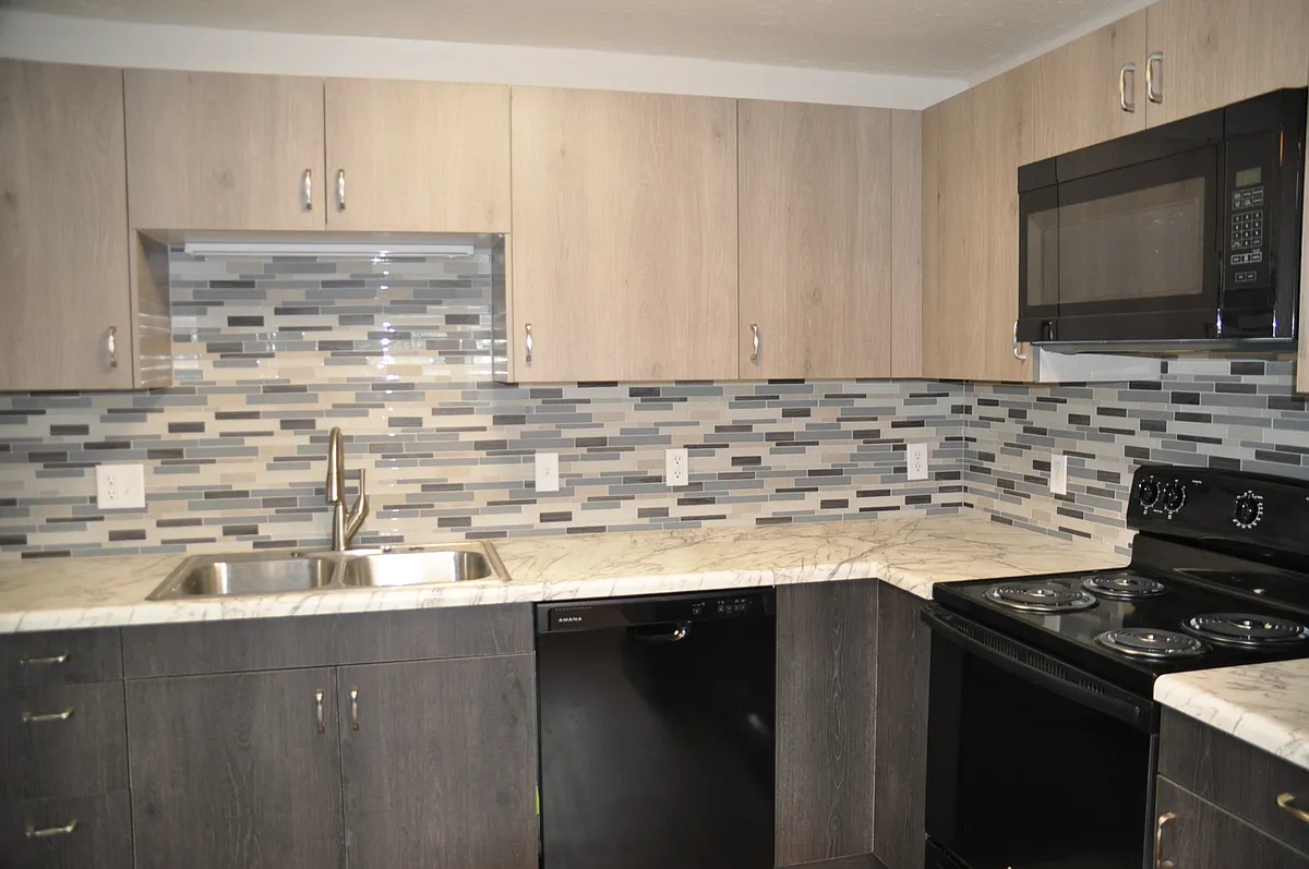 New kitchen cabinets, counter top, tile backsplash, and appliances. Separate pantry in the kitchen. - 2389 Riverside Dr