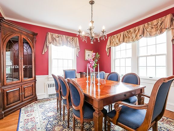 Sun filled dining room with chair rail moldings.