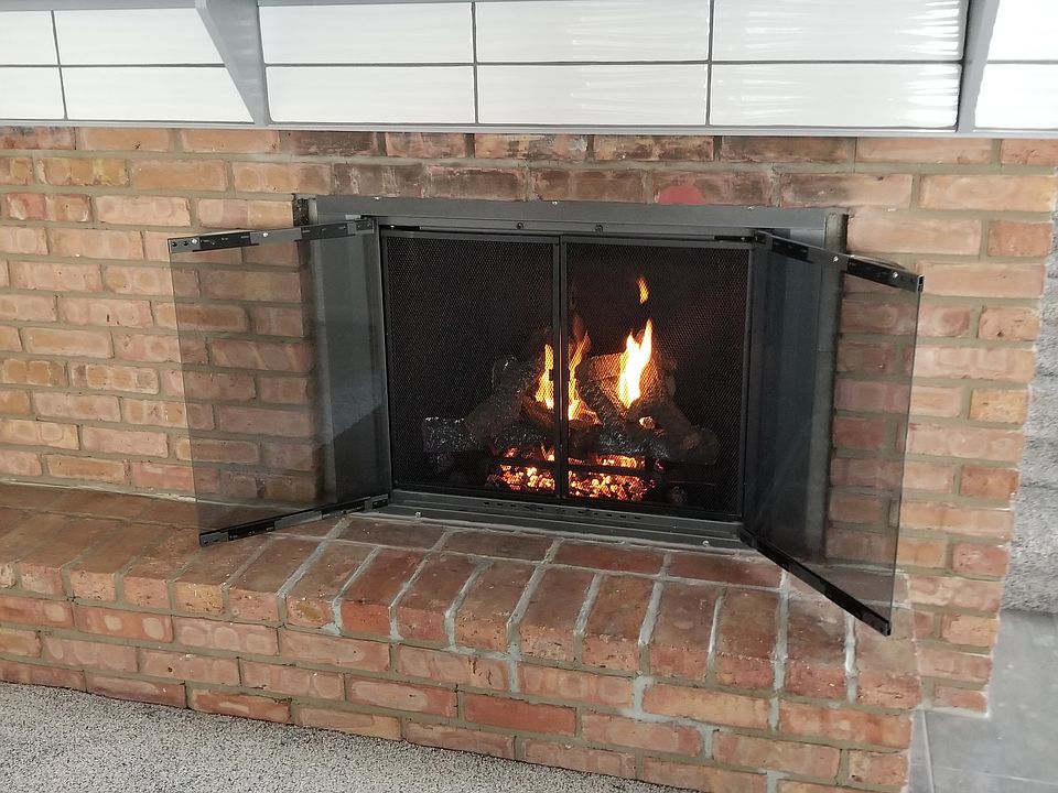 Cozy gas log fireplace with brick hearth!