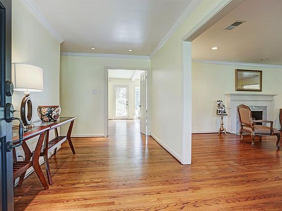 Gleaming hardwood floors and crown molding grace the oversized entry that flows into the living areas.
