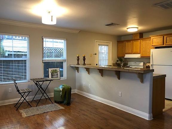 View of the open concept kitchen and living space with bar counter.