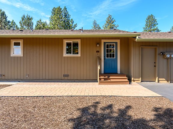 Front door next to attached garage