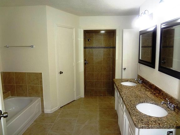Master Bath with dual sink and his and her closets
