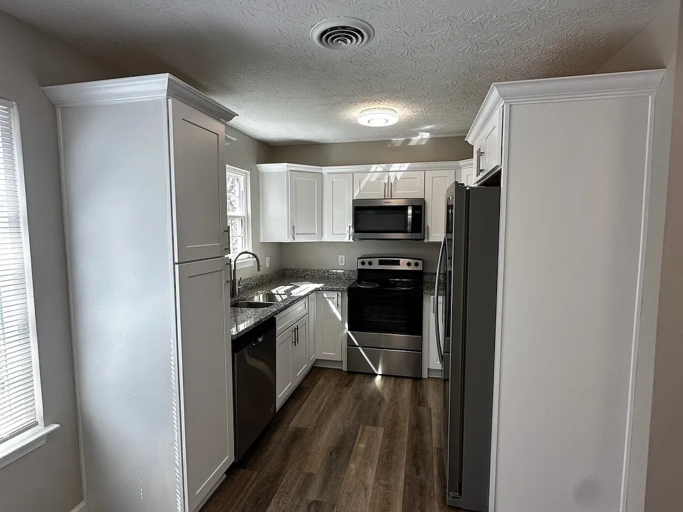 Updated kitchen with soft-close real wood cabinetry, granite countertops and a full appliance package.