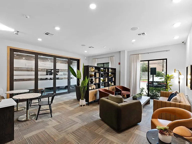 Soak in natural light and stay productive in a modern lounge with spacious work areas and large windows.