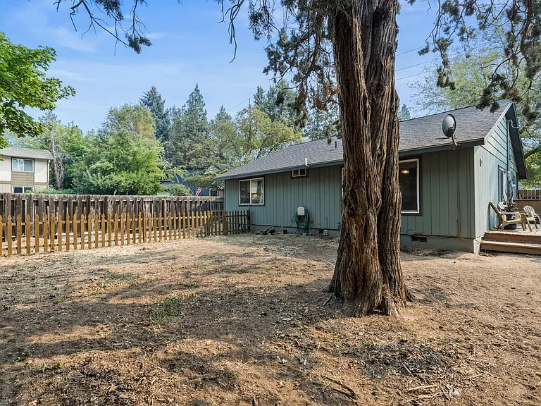 Large fenced in backyard with separate garden area.