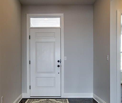 Front entryway with transom window above door.