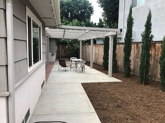 Backyard patio with walkway to side yard.