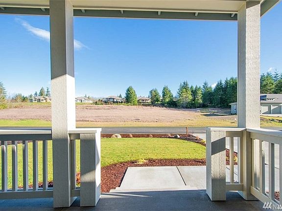 Covered front porch gives you a comfortable place to sit and enjoy the neighborhood. PHOTO OF SIMILAR HOME ON NEARBY LOT>