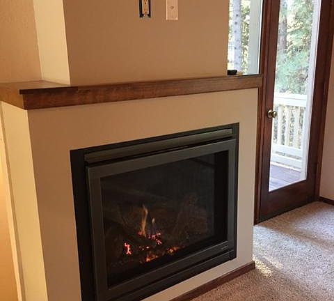Living Room gas fireplace and door to deck