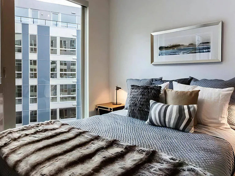 Bedroom with Tall Windows and Coordinated Bedding and Wall Art