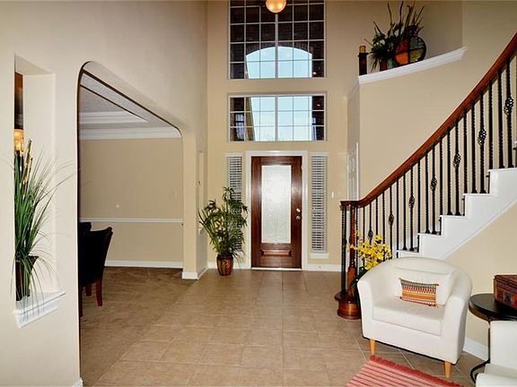 From the moment you enter, you will see the dining room entry and spiral wrought iron staircase.