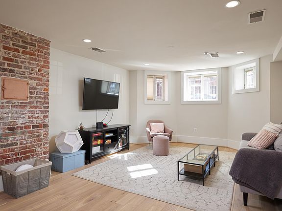 Exposed brick accent wall in living room