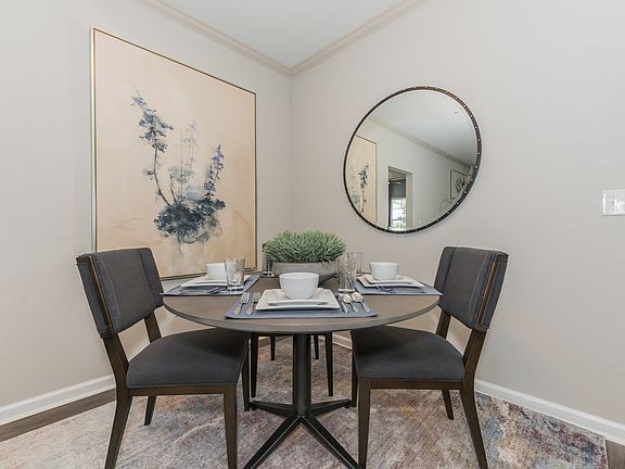 Interior Photo Of the dining room with wood flooring and crown molding