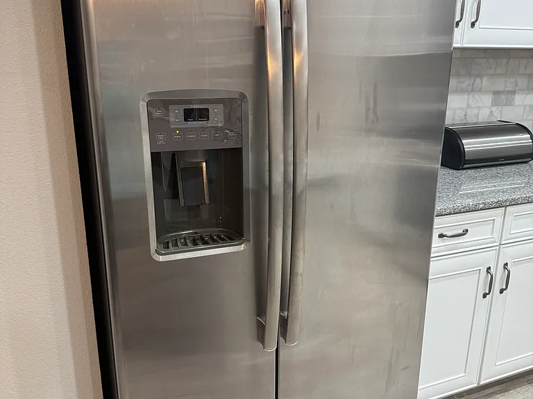Full sized refrigerator with water and ice outside door