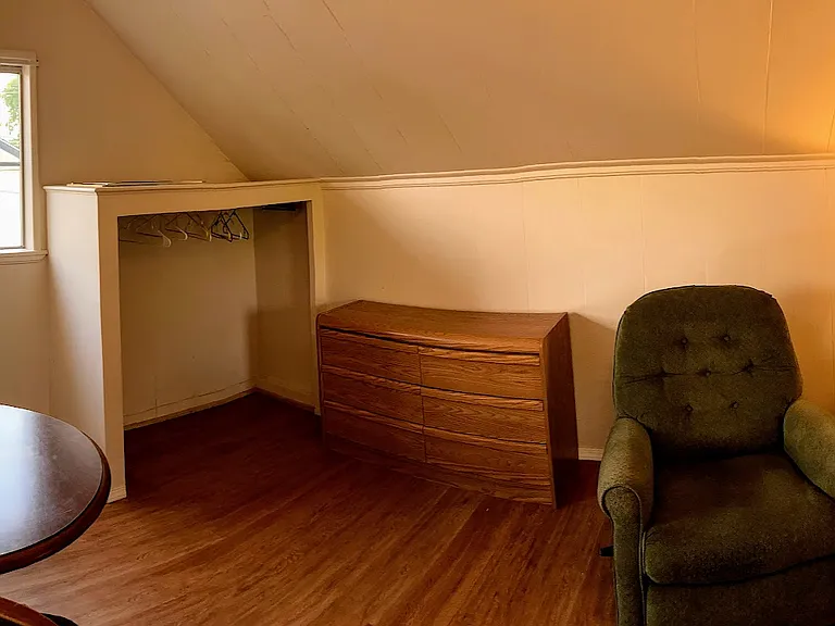 This is the East side of the upstairs room over the living room with a small 3/4 closet. Some of the furniture has been moved around, so updated photos will be posted soon
