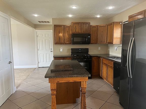 Granite Counters, Center Island with space for seating , Stainless Refrigerator, Natural Gas Stove for cooking, kitchen window with views to the backyard, double sinks, large pantry.