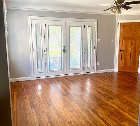 Living room, double front door, and corner door to private laundry room.