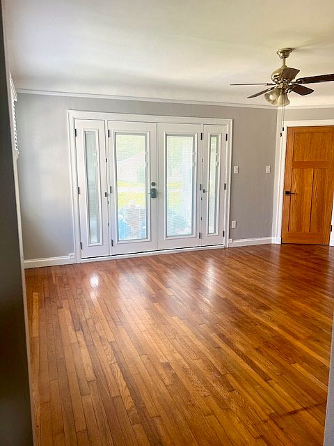 Living room, double front door, and corner door to private laundry room.