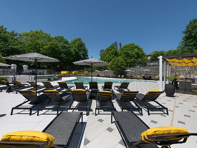 Expansive Pool Deck with Lounge Chairs