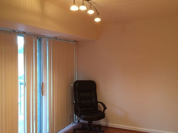 Living Room w/ wood floors , updated lighting and balcony