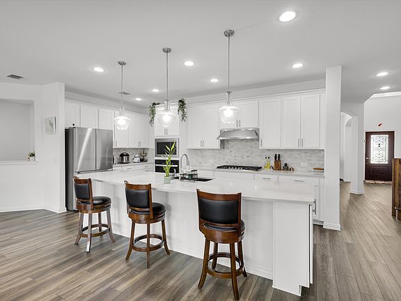 Kitchen with quartz counter tops and modern finishes.