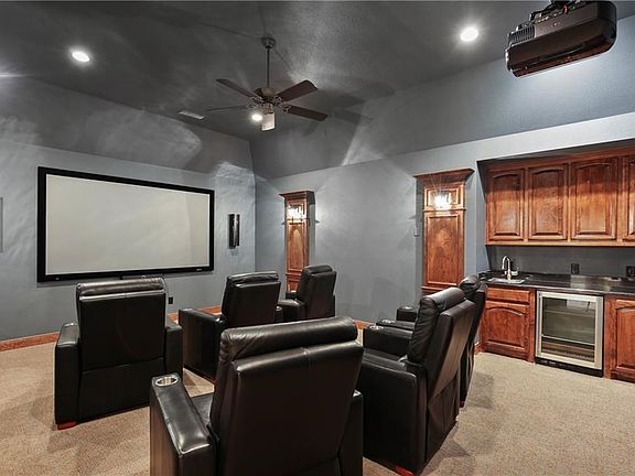 Entertain in the private media room equipped with a projector, screen & granite wet bar with a mini fridge.