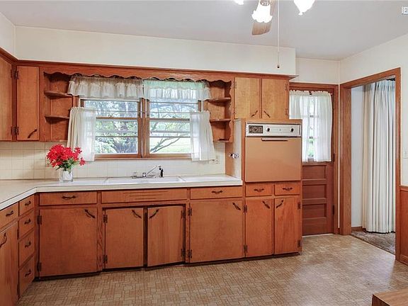 Kitchen is on the back of the home with an abundance of counter top and cabinet space. The door leads to the patio.